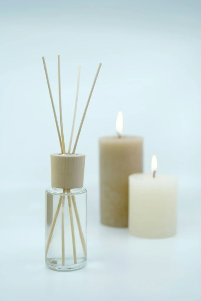 photo of two candles and scented sticks