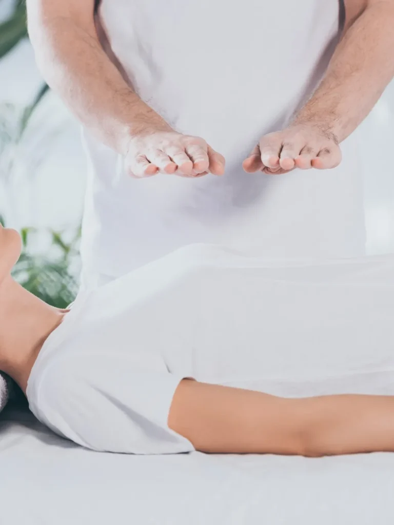 male therapist offering a reiki session to female patient
